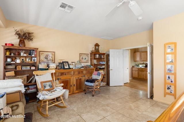 tiled office space featuring ceiling fan