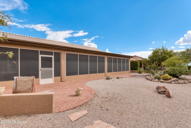 back of house featuring a patio area and a sunroom