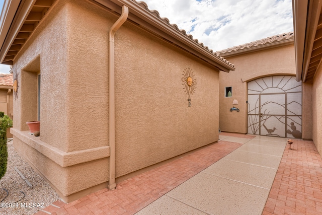 view of property exterior with a patio area