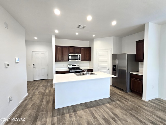 kitchen with a center island with sink, stainless steel appliances, and hardwood / wood-style floors