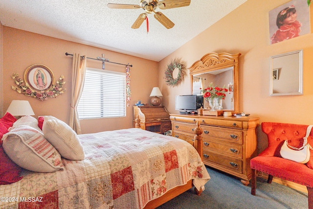 carpeted bedroom featuring ceiling fan and a textured ceiling