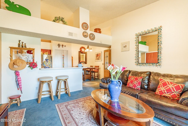 carpeted living room featuring a textured ceiling, a towering ceiling, and a chandelier