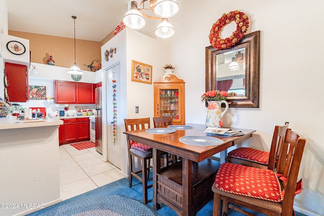 tiled dining room with a notable chandelier