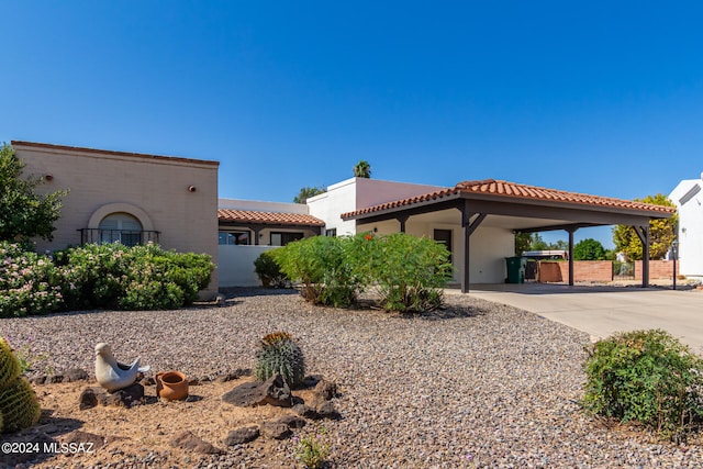 mediterranean / spanish-style home with a carport