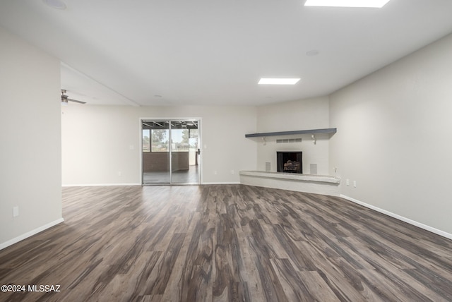 unfurnished living room with ceiling fan and hardwood / wood-style floors