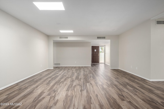 unfurnished room with hardwood / wood-style flooring