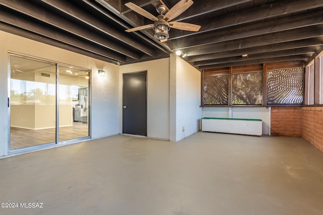 interior space with concrete flooring and ceiling fan