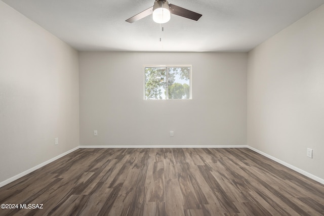 unfurnished room with dark wood-type flooring and ceiling fan