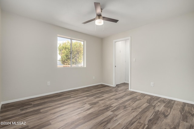 spare room featuring ceiling fan and dark hardwood / wood-style floors