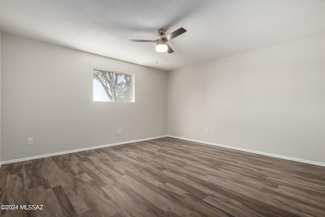 unfurnished room with ceiling fan and dark hardwood / wood-style flooring