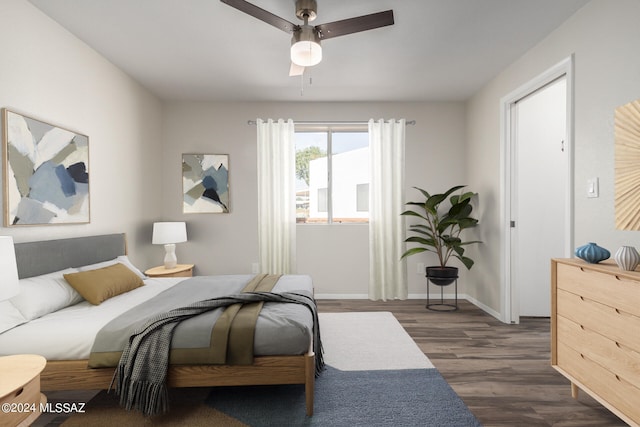 bedroom with ceiling fan and dark hardwood / wood-style floors