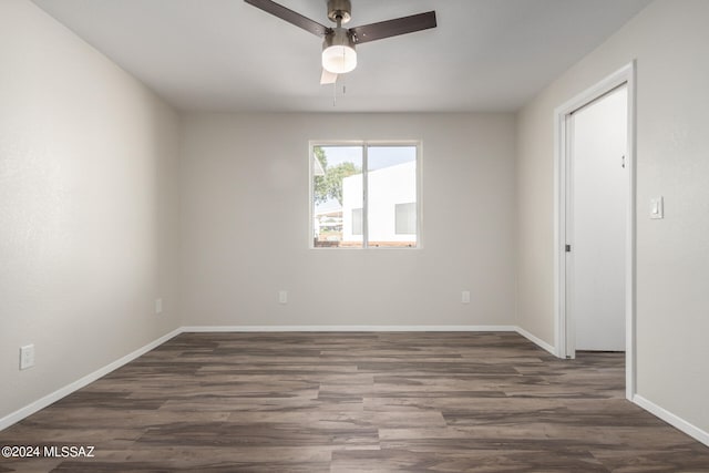 unfurnished room with ceiling fan and dark hardwood / wood-style flooring