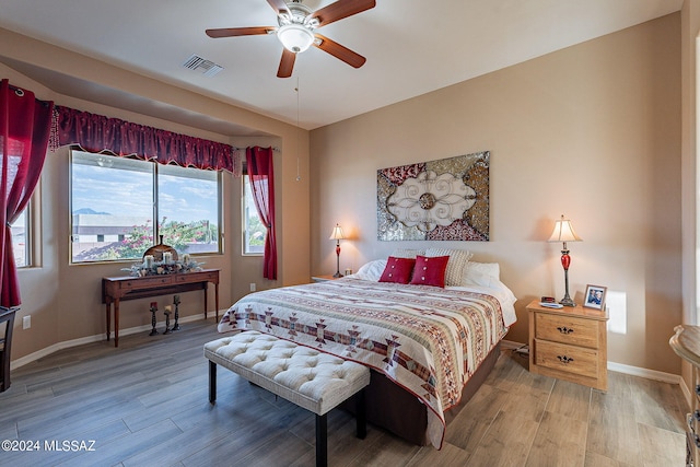 bedroom with wood-type flooring and ceiling fan