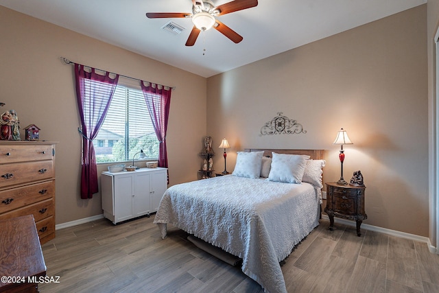 bedroom featuring ceiling fan and light hardwood / wood-style flooring