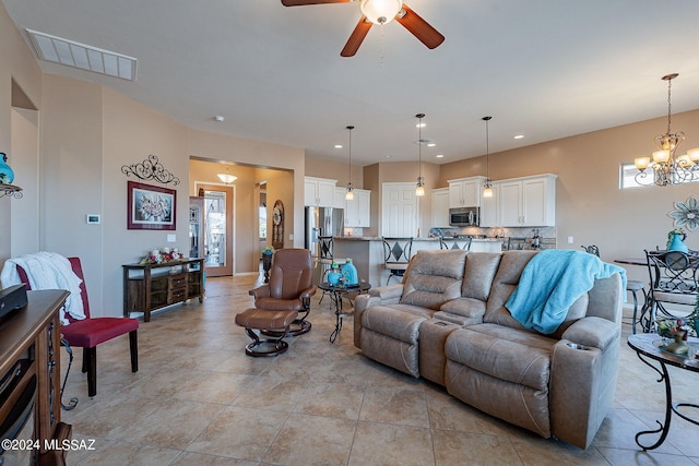 living room with a healthy amount of sunlight, ceiling fan with notable chandelier, and light tile patterned flooring