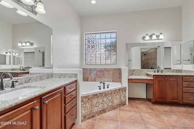 bathroom featuring tile patterned flooring, independent shower and bath, and vanity