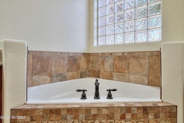 bathroom with tiled bath