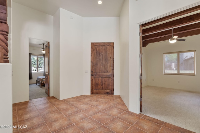 interior space featuring beamed ceiling and ceiling fan