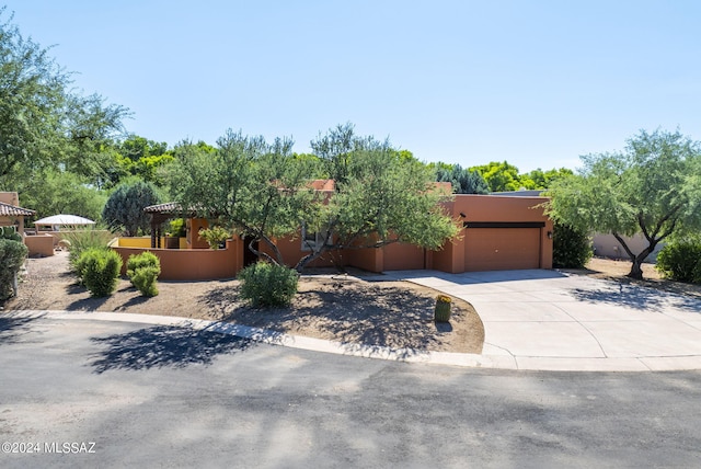 pueblo revival-style home with a garage