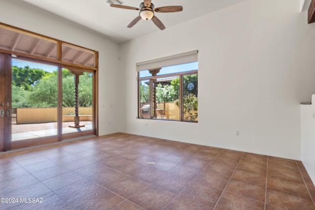 spare room with ceiling fan and tile patterned floors