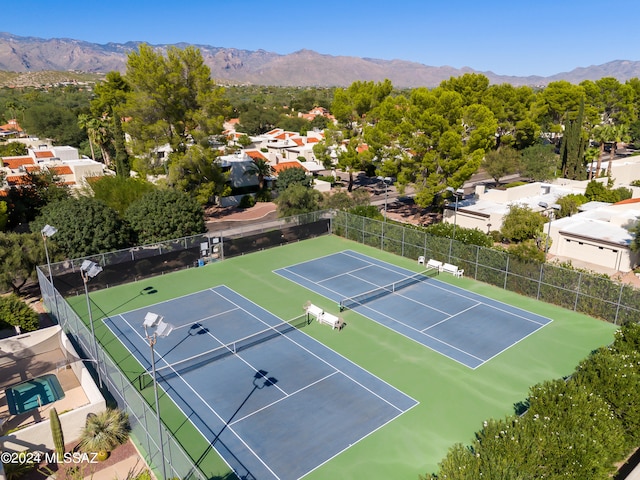 view of tennis court featuring a mountain view and basketball court