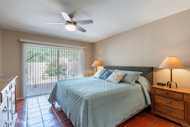 bedroom featuring ceiling fan, access to exterior, and dark tile patterned flooring