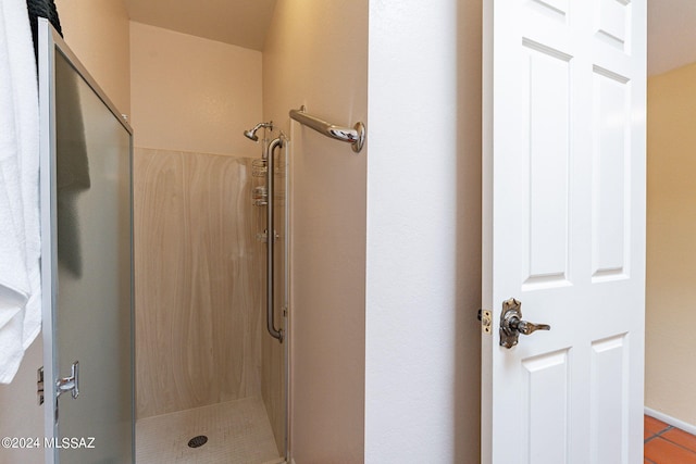full bathroom featuring tile patterned flooring and a stall shower