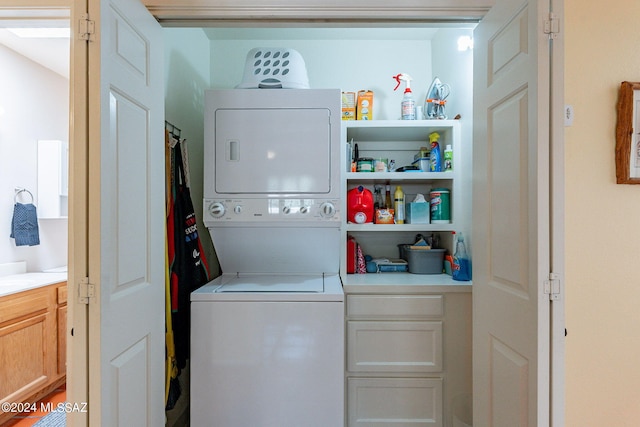 laundry area featuring stacked washer / drying machine