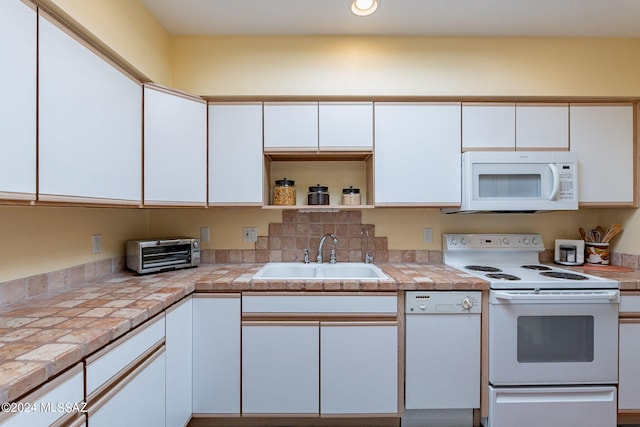 kitchen featuring open shelves, a toaster, white appliances, white cabinetry, and a sink