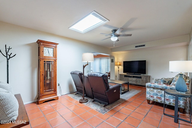 living room with visible vents, ceiling fan, and light tile patterned floors
