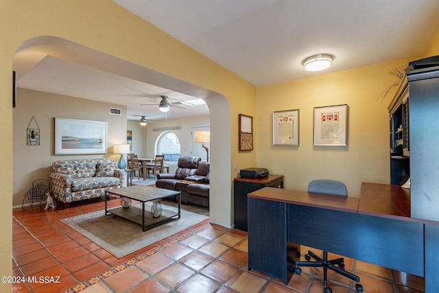 interior space with arched walkways, ceiling fan, visible vents, and tile patterned flooring