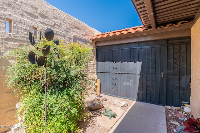 exterior space with stucco siding and a tile roof