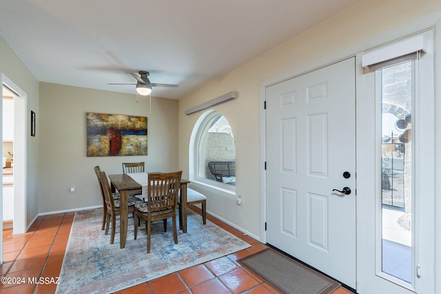 tiled dining space with ceiling fan