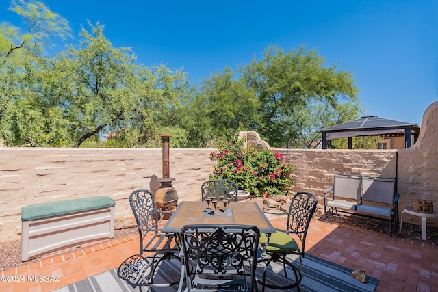 view of patio / terrace featuring a gazebo and outdoor dining area