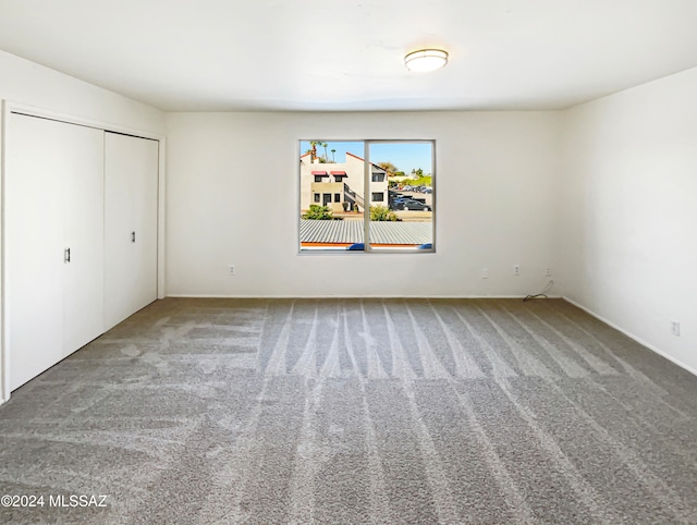 unfurnished bedroom with a closet and carpet floors