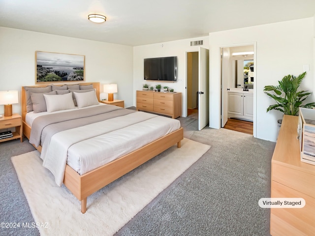 carpeted bedroom with ensuite bathroom