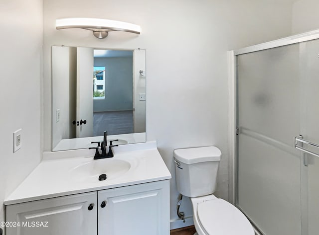 bathroom with vanity, walk in shower, and toilet