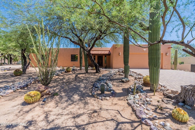 pueblo-style home with a garage