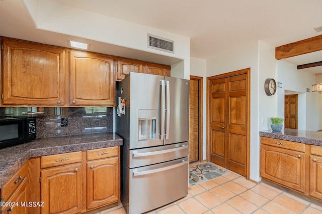 kitchen with stainless steel refrigerator with ice dispenser, light tile patterned floors, decorative backsplash, and beam ceiling