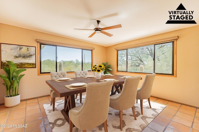 dining area featuring ceiling fan and light tile patterned floors