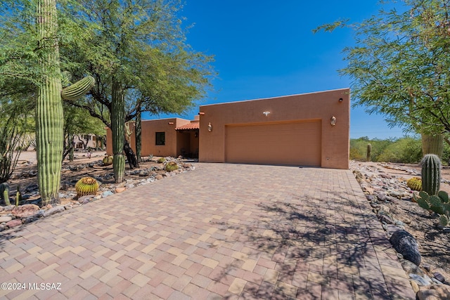 pueblo-style house with a garage