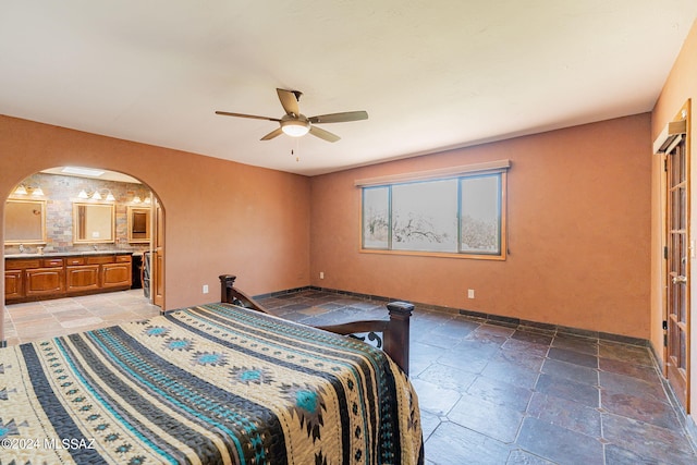 bedroom featuring ceiling fan, sink, and connected bathroom