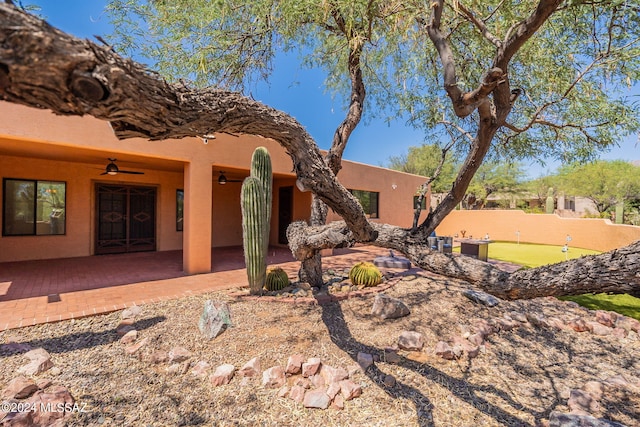 exterior space with ceiling fan and a patio area