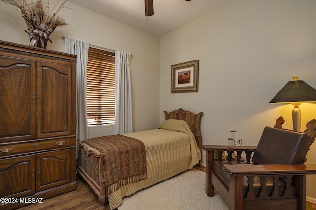 bedroom with ceiling fan, light hardwood / wood-style floors, and lofted ceiling