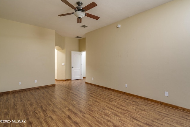 empty room featuring wood-type flooring and ceiling fan