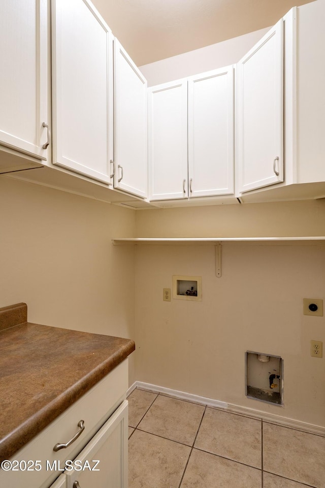 laundry area with cabinets, light tile patterned flooring, electric dryer hookup, and washer hookup