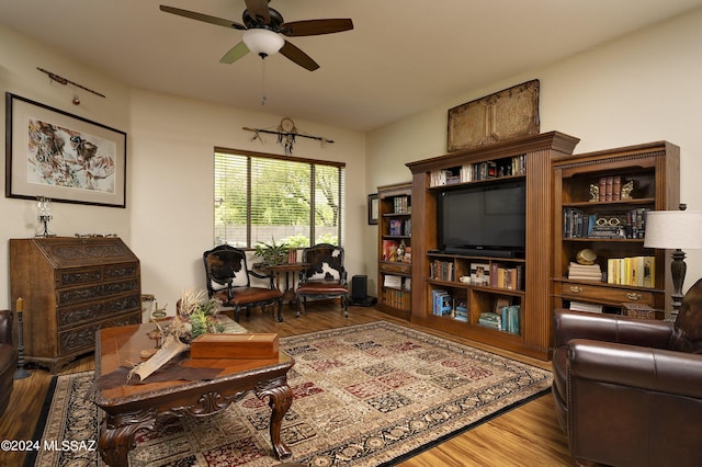 living room with wood-type flooring and ceiling fan