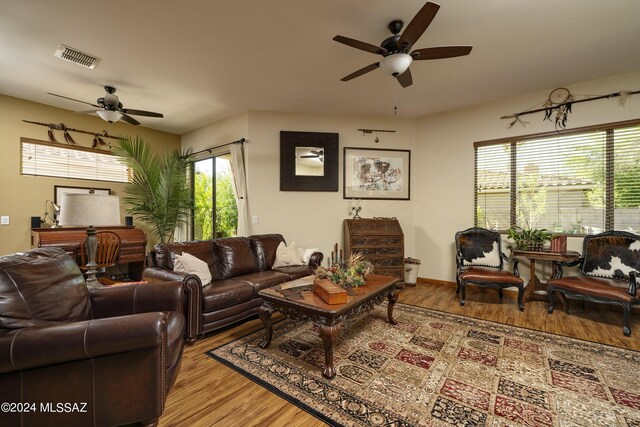 kitchen featuring stainless steel fridge, sink, light stone countertops, and light hardwood / wood-style floors