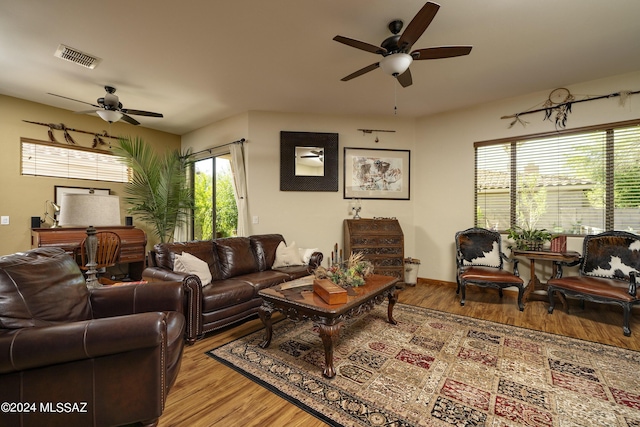 living room featuring ceiling fan and light hardwood / wood-style floors