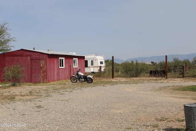 view of yard featuring an outbuilding and a mountain view